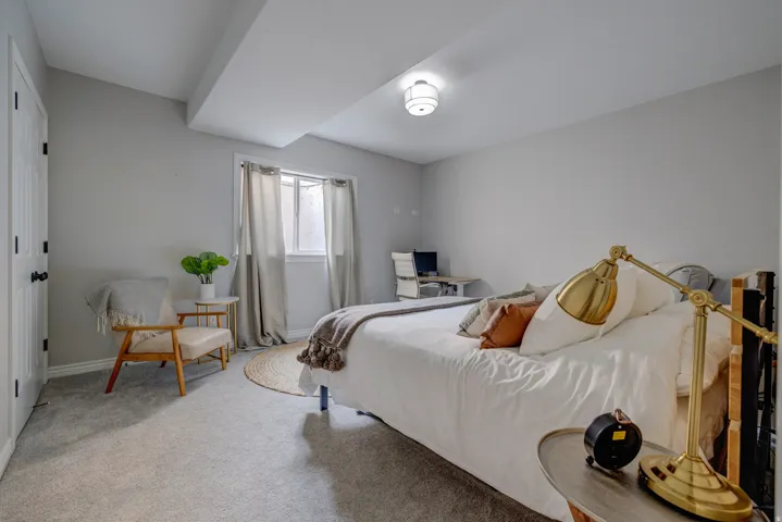 Soft gray carpeting throughout, recessed window, light gray wall paint, and overhead flush-mount lighting