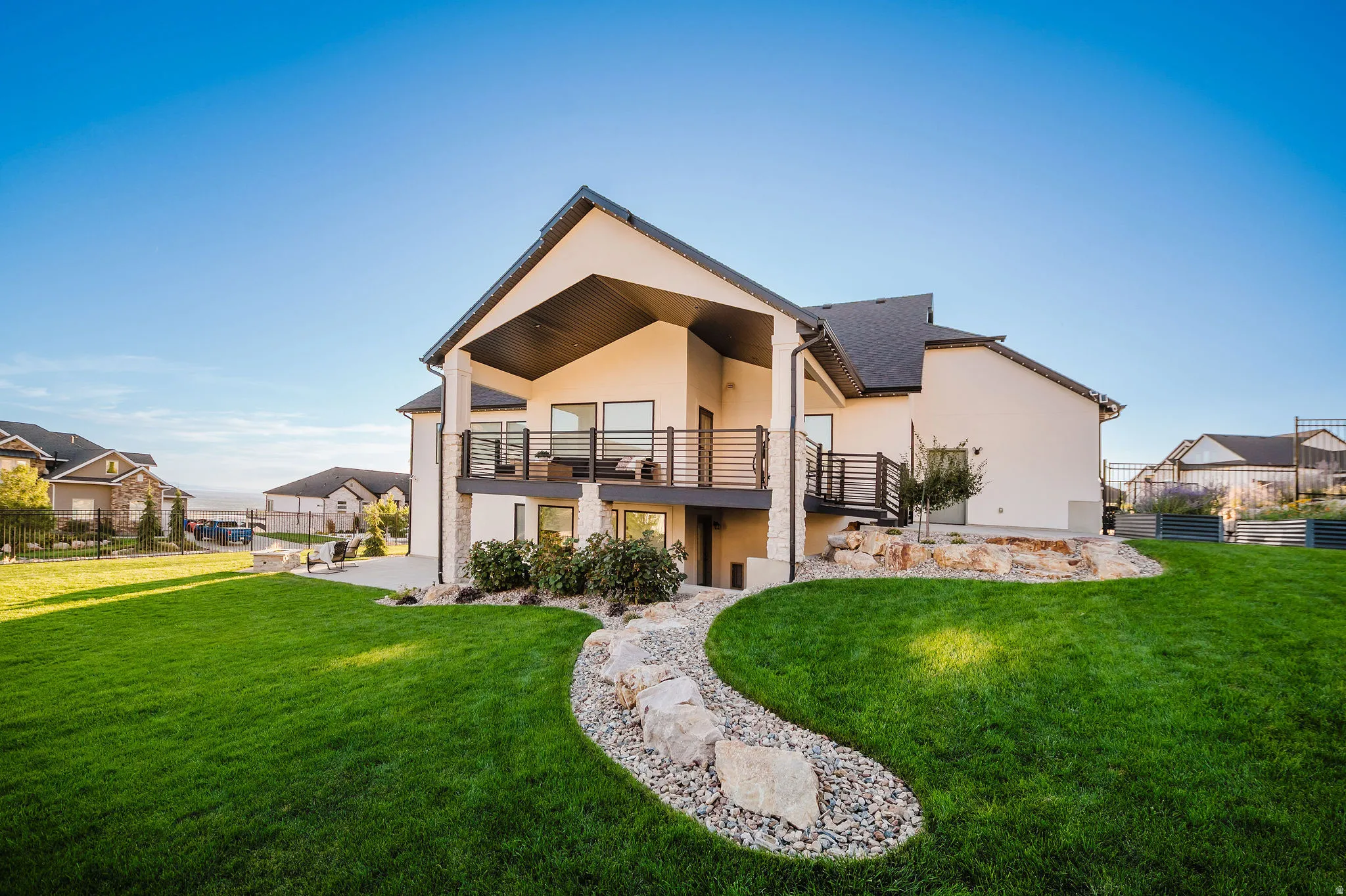 Expansive manicured lawn with decorative rock landscaping