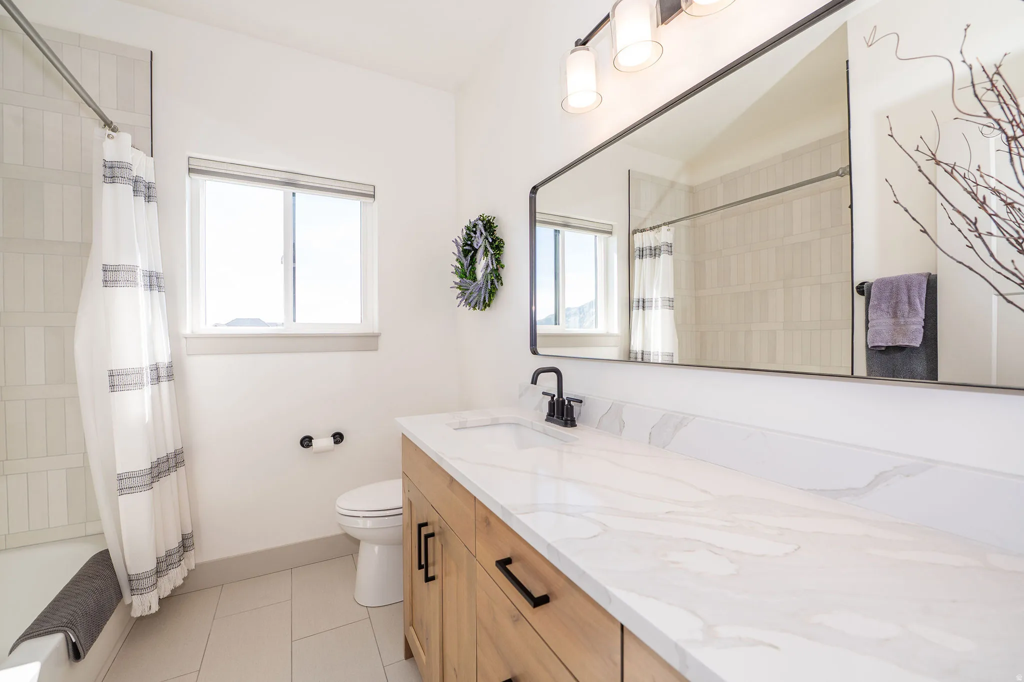 Level 1 Full Bathroom #2 Featuring Large Countertop & Bathtub with Tiled Surround