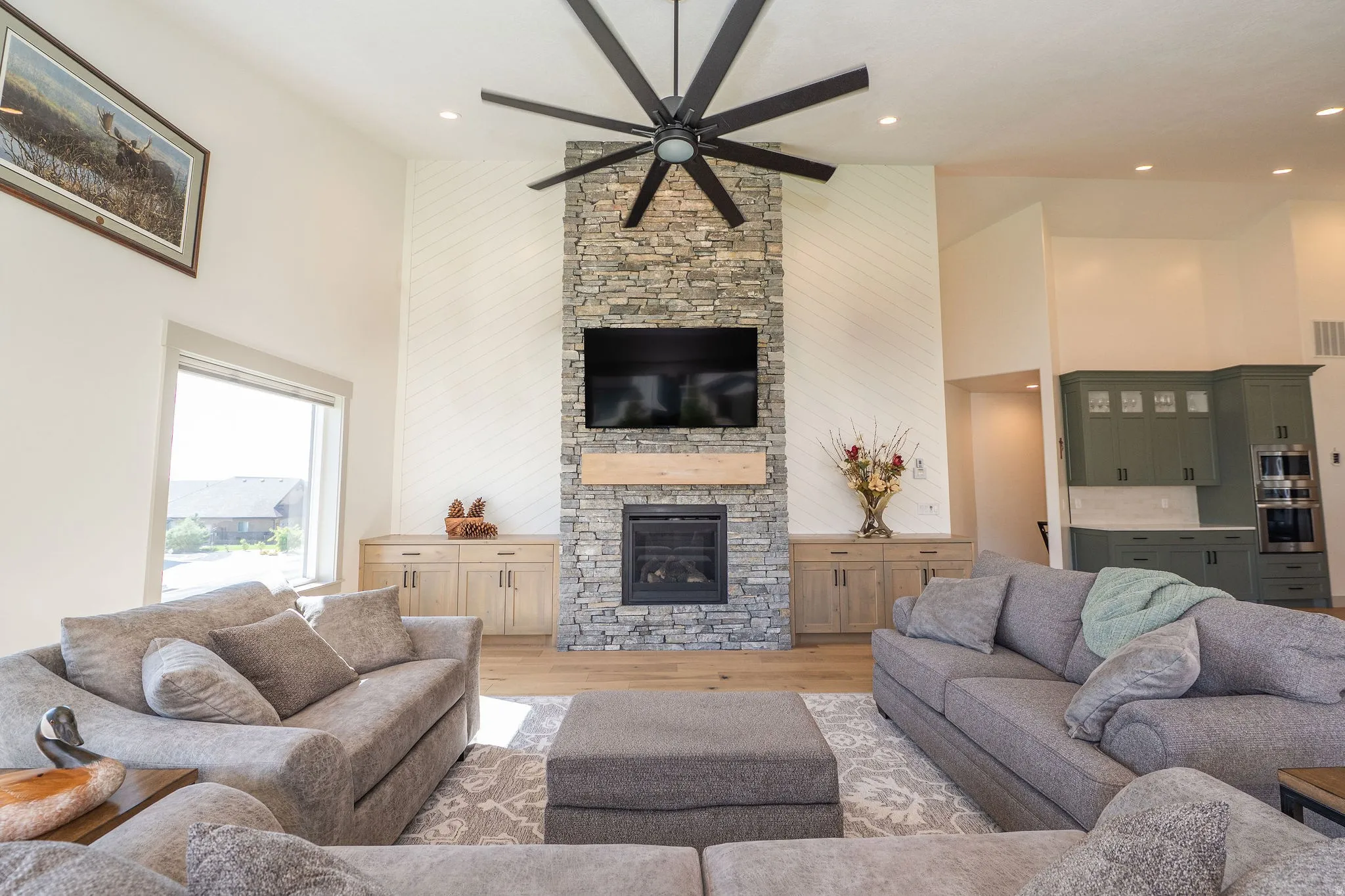 Cozy Stone Fireplace with Wood mantel, and Built-in Cabinetry