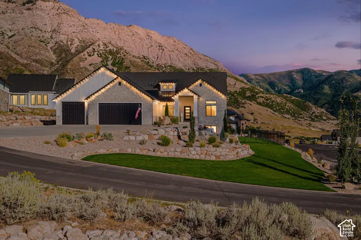 Stone and siding exterior with a dark shingle roof