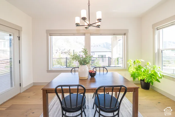 Bright Dining Room Featuring Multiple Windows and a Glass-Paneled Door Leading onto The Deck