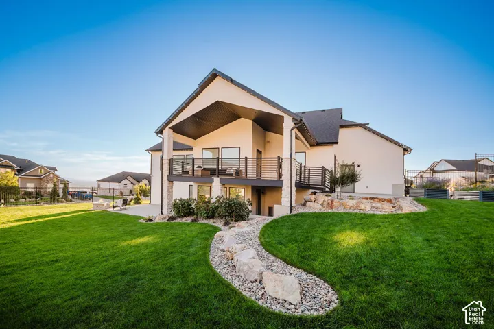 Expansive manicured lawn with decorative rock landscaping