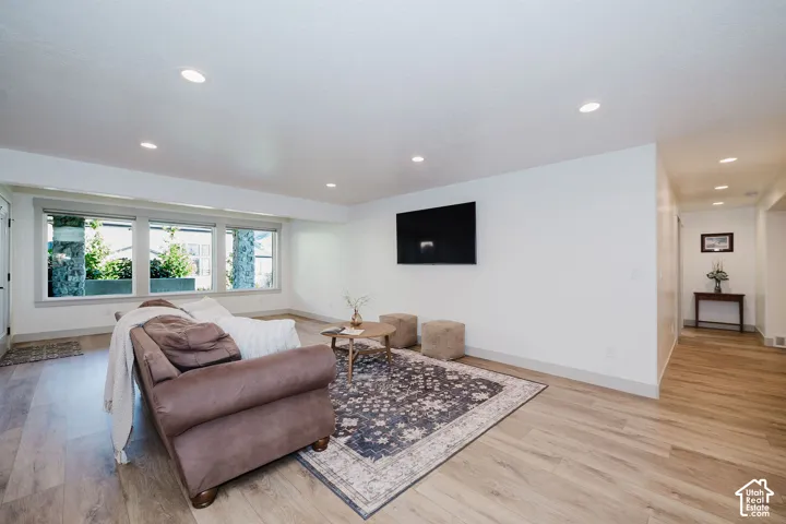 Living Room With Daylight Basement, Recessed Lighting, And Multiple Large Windows