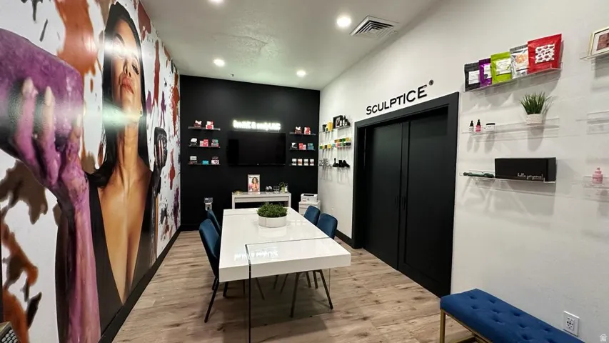 Wood-finish flooring, recessed lighting, and a white tabletop