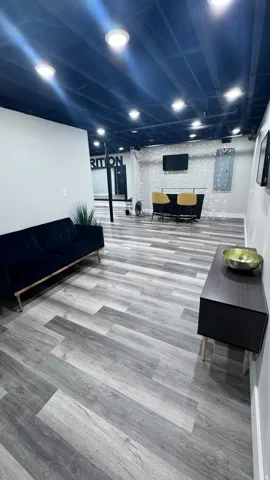 Gray wood-finish flooring with recessed lighting
