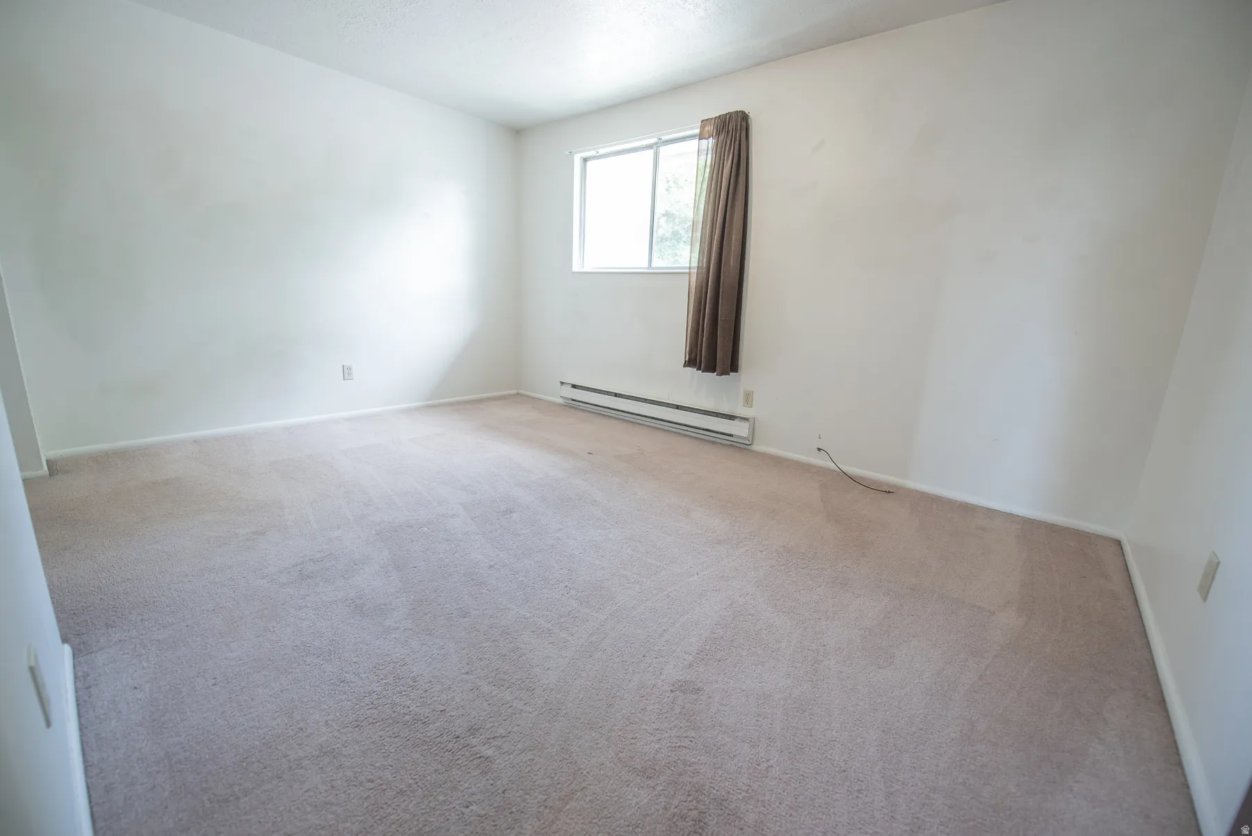 Wall-to-wall carpeting with a light neutral tone