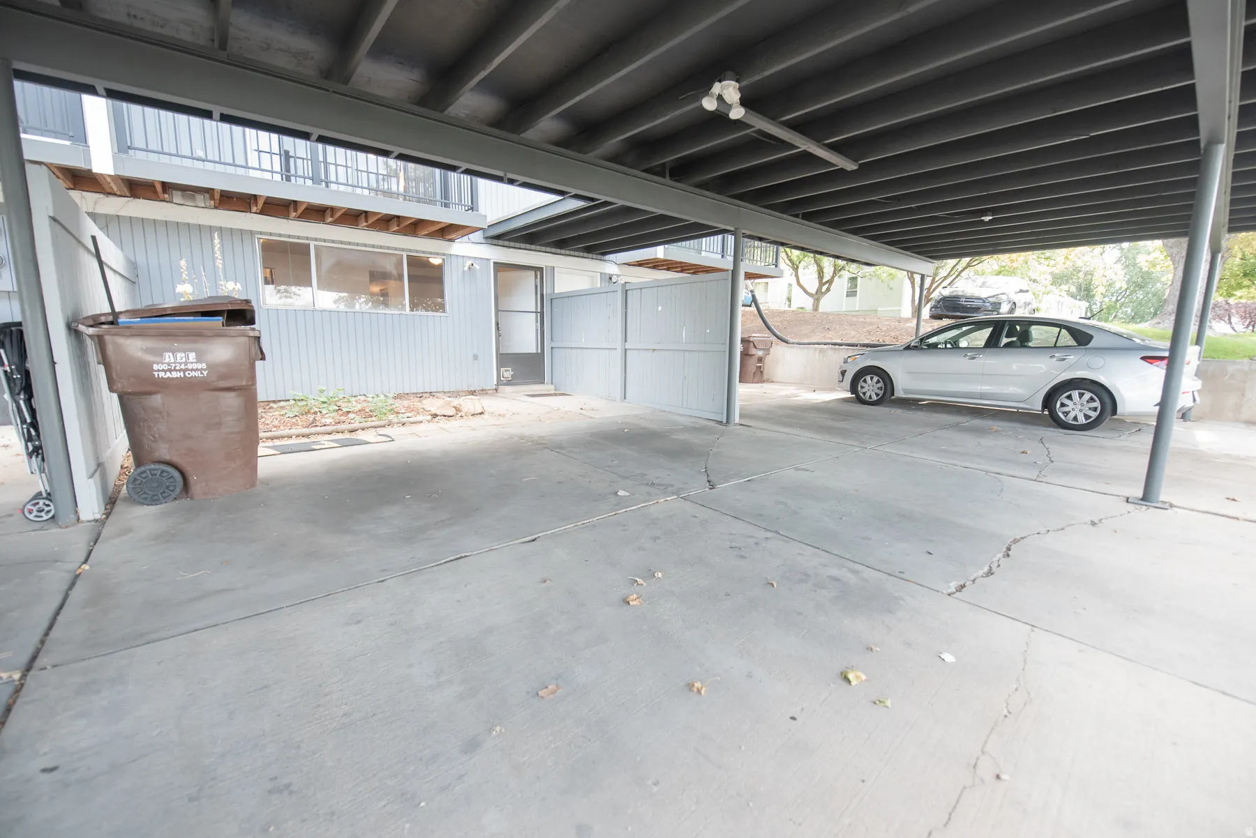 Covered parking space with concrete flooring