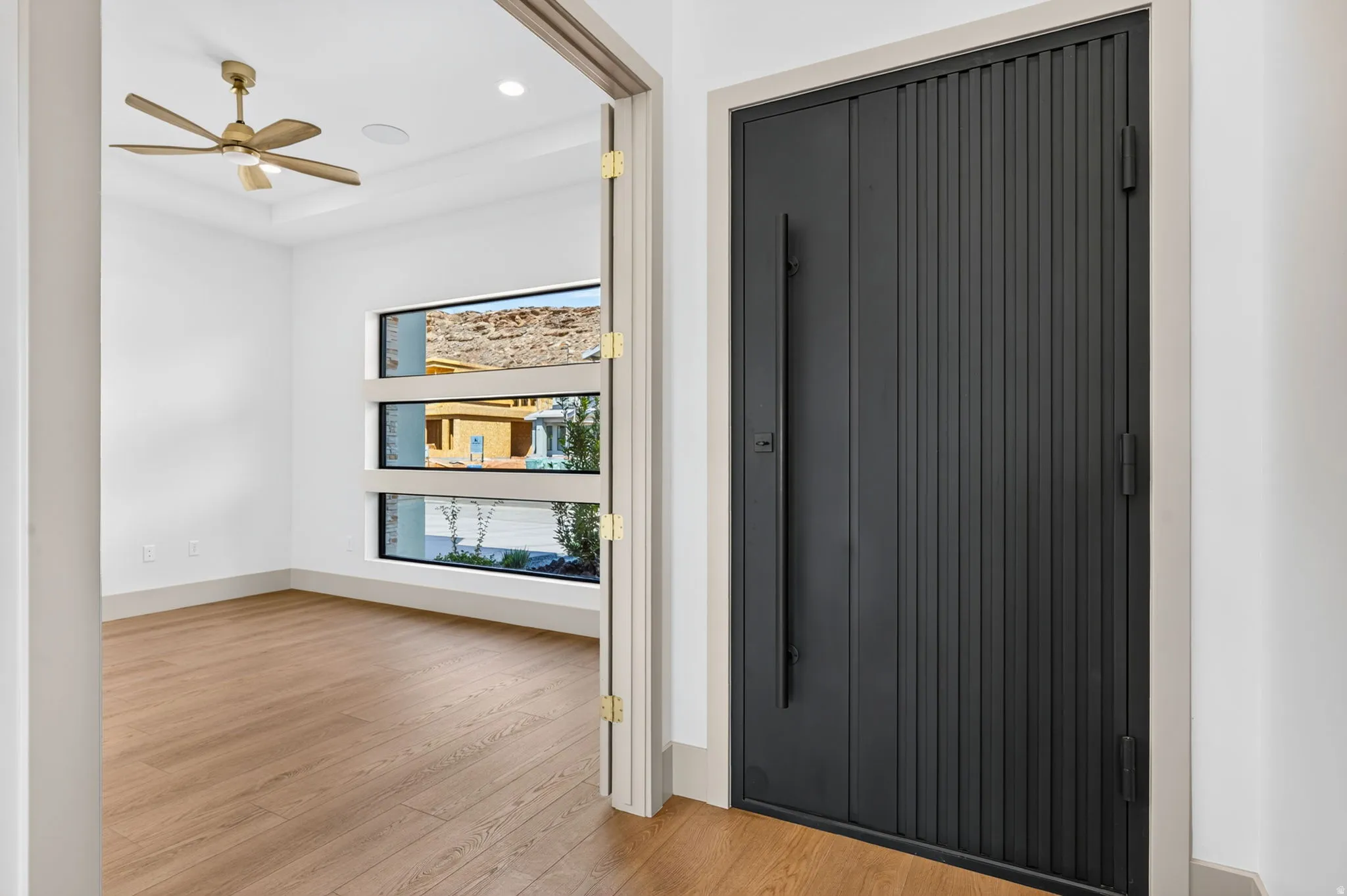 Modern entry door with vertical paneling and a dark finish