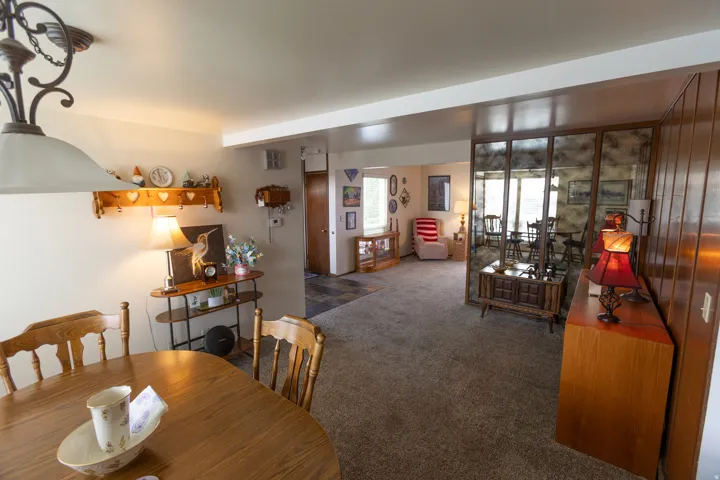 Recessed lighting, wood-paneled accent wall, and built-in mirrored wall feature