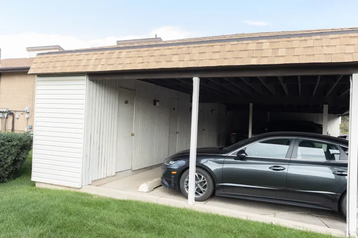 Covered parking structure with asphalt shingle roofing
