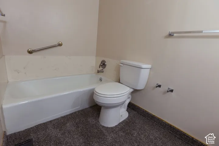 White bathtub with a chrome grab bar