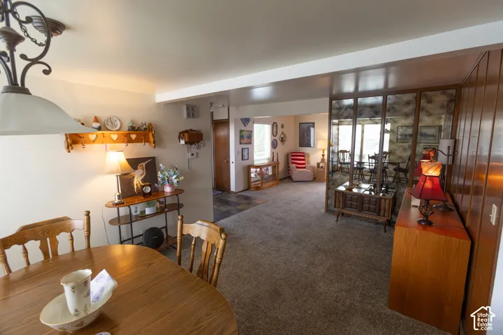 Recessed lighting, wood-paneled accent wall, and built-in mirrored wall feature