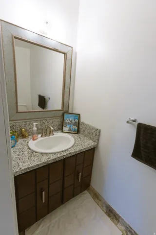 Vanity with a granite countertop and an undermount sink