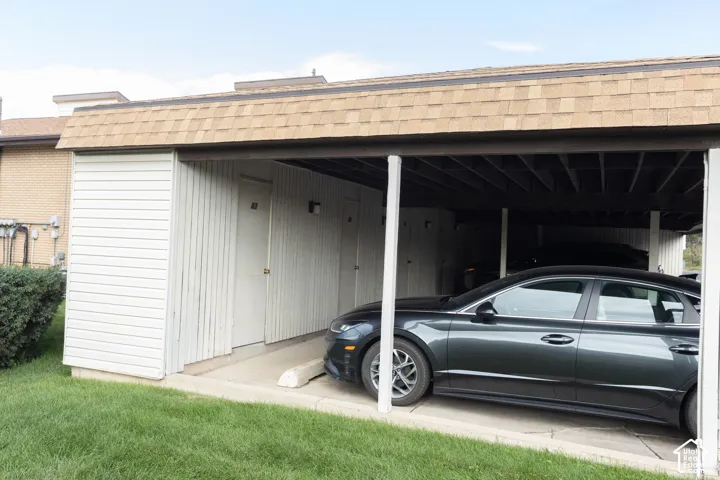 Covered parking structure with asphalt shingle roofing