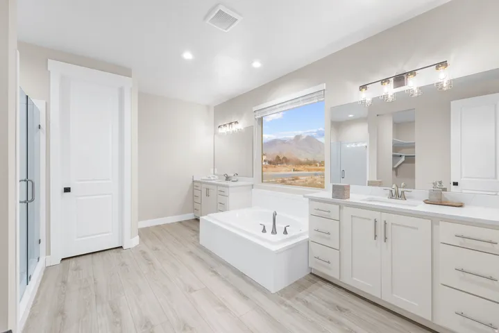 Dual vanity with white cabinetry and integrated sinks