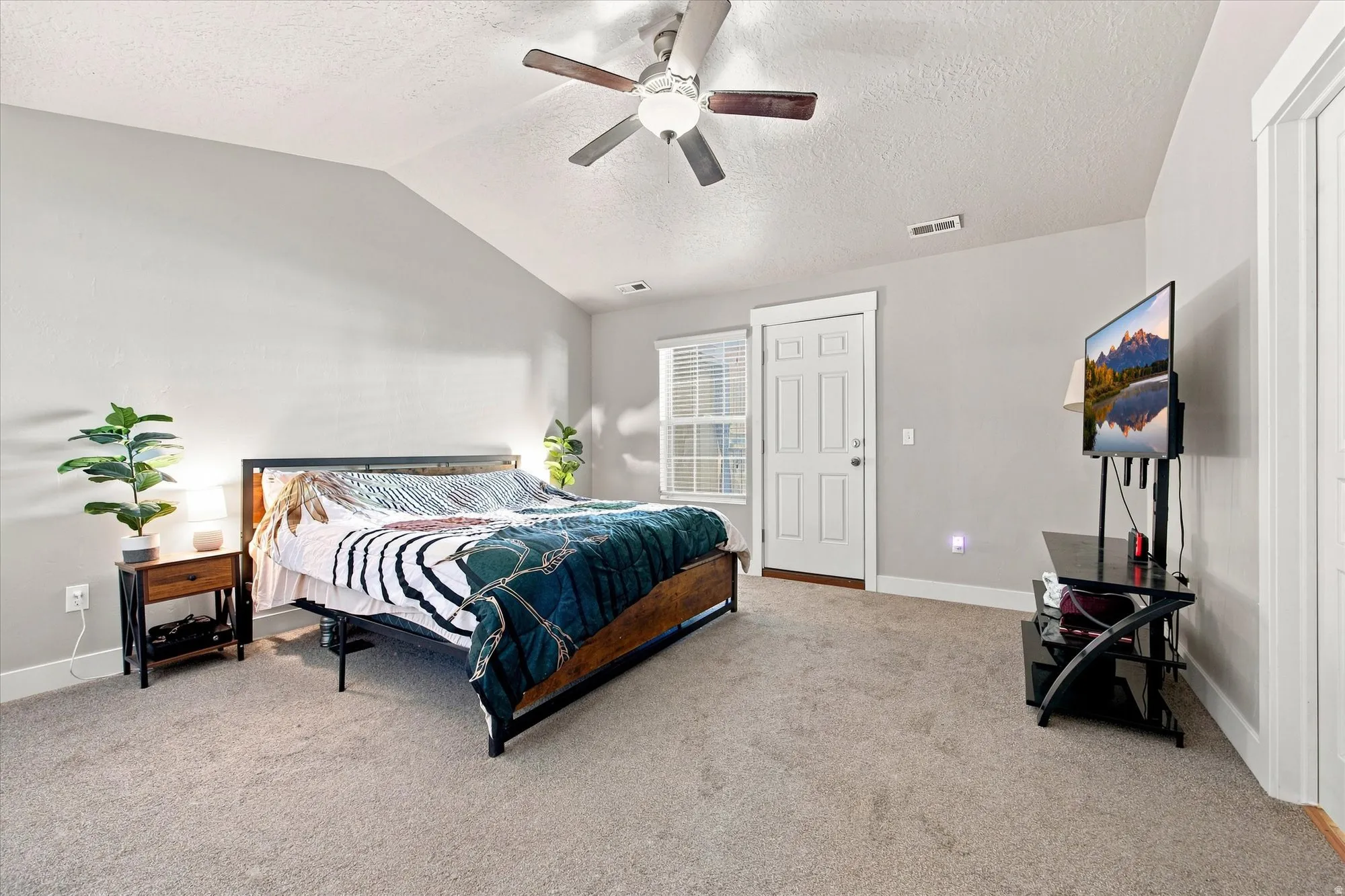 Primary bedroom with door leading out to private balcony/