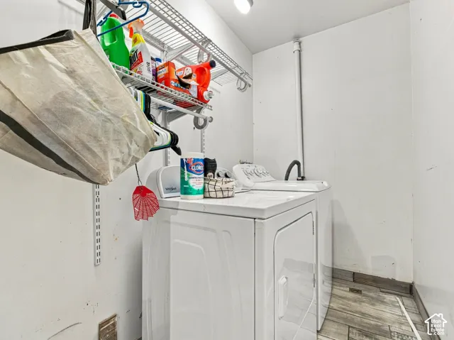 Dedicated laundry area with durable flooring and overhead wire shelving
