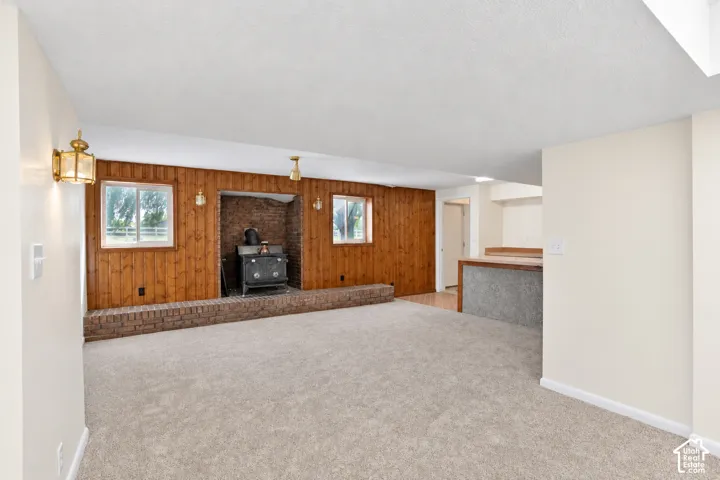 family room and kitchen area with brick hearth and wood-burning stove door goes to walkout