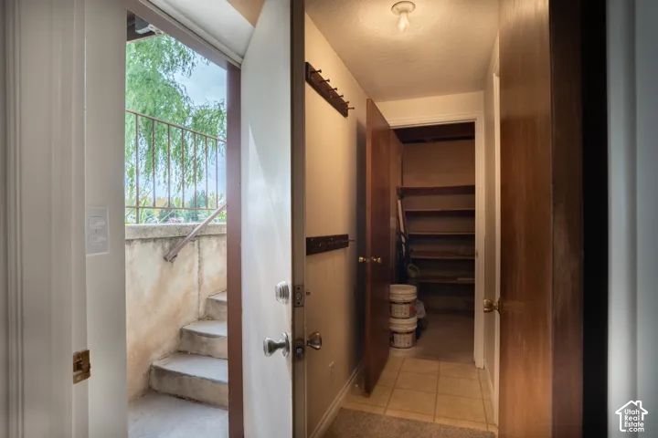 Entryway featuring a built-in coat rack, hall to the laundry and storage room, and walkout basement.