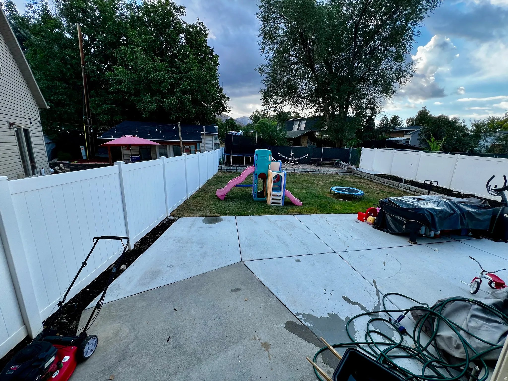 Concrete patio with a grass area