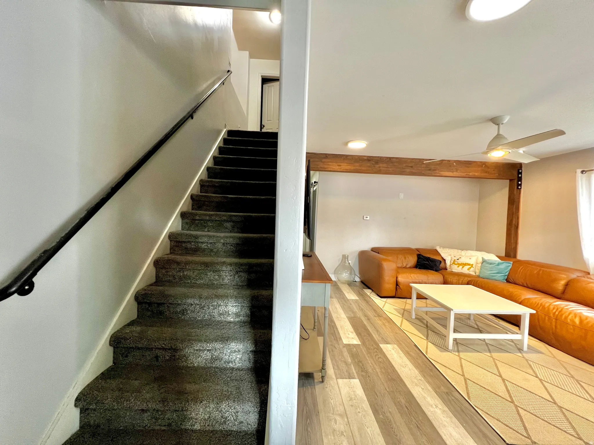 Carpeted staircase with wall-mounted handrail