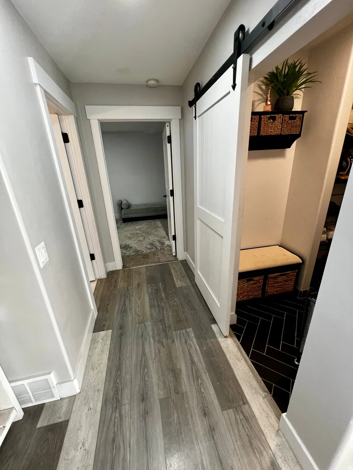 Wood-finish flooring throughout the hallway