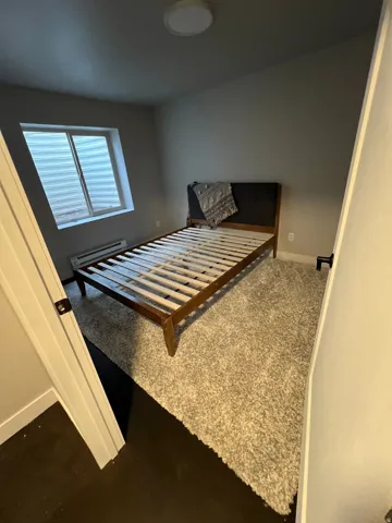 Recessed window, warm grey wall paint, and overhead flush-mount lighting