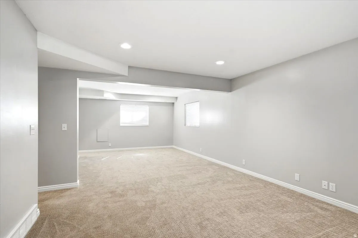 Expansive carpeted room featuring recessed lighting and light-toned walls