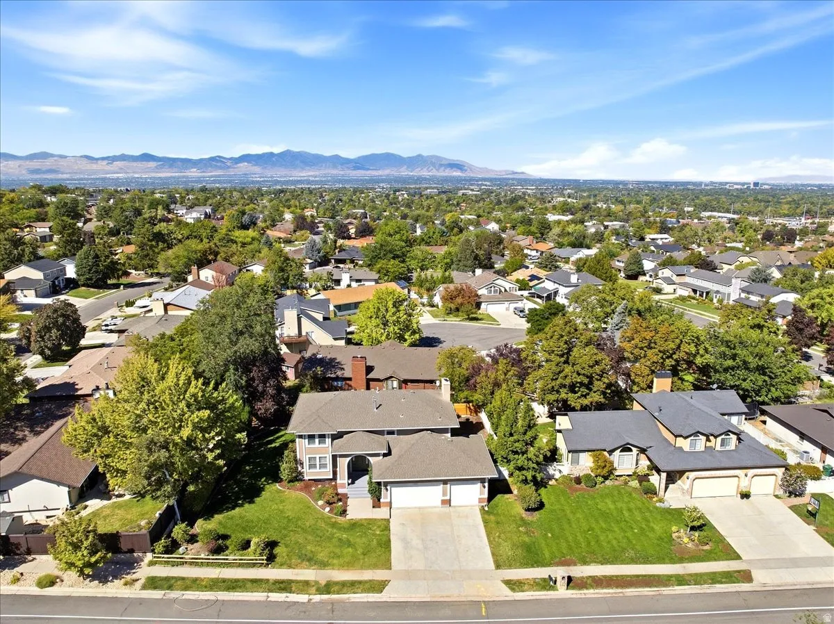Expansive suburban neighborhood with established landscaping and mountain backdrop