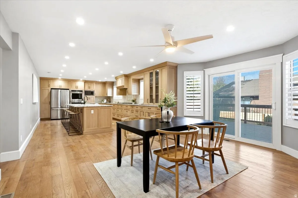 Open concept living area featuring wood-finish flooring, recessed lighting, and a modern ceiling fan