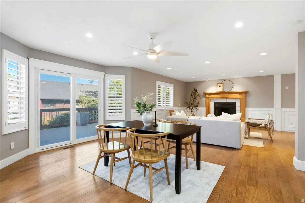 Hardwood flooring throughout, recessed lighting, and a wood-mantel fireplace with a tile surround