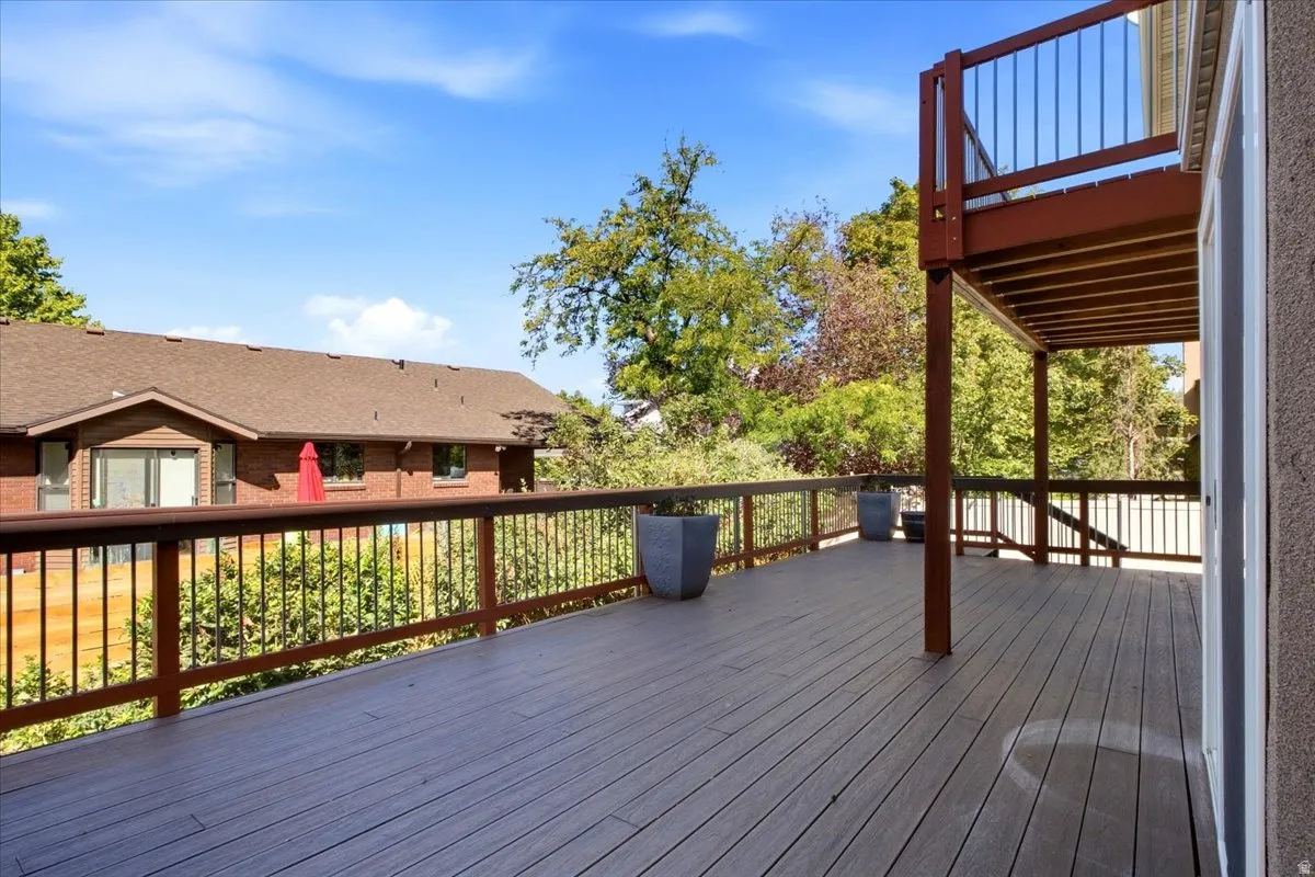 Expansive multi-level deck featuring composite decking and dark wood railings with metal spindles