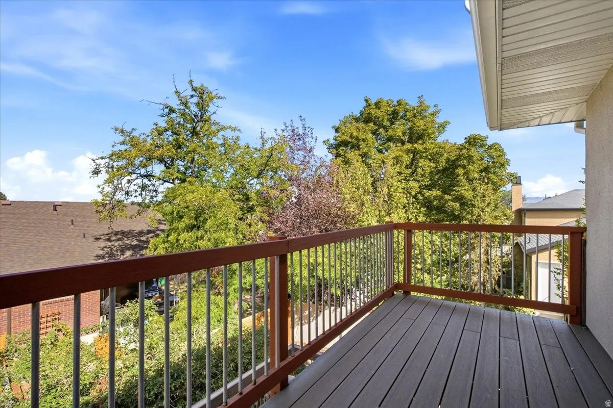 Expansive outdoor deck featuring composite decking, wood-finish railing, and metal balusters