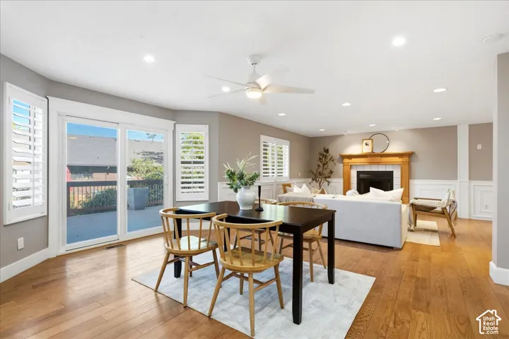 Hardwood flooring throughout, recessed lighting, and a wood-mantel fireplace with a tile surround