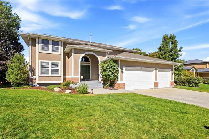 Stucco exterior with a two-story elevation, arched entry, and a two-car garage