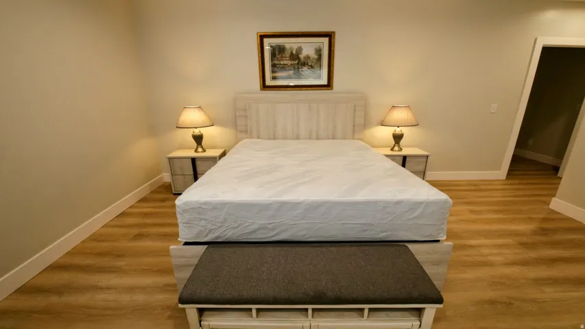 Wood-finish flooring, light-toned walls, and recessed lighting