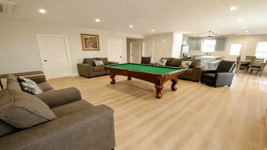 Open-concept common area featuring recessed lighting, wood-finish flooring, and white interior doors