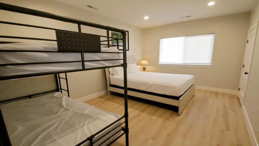 Recessed lighting, wood-finish flooring, and light-toned walls
