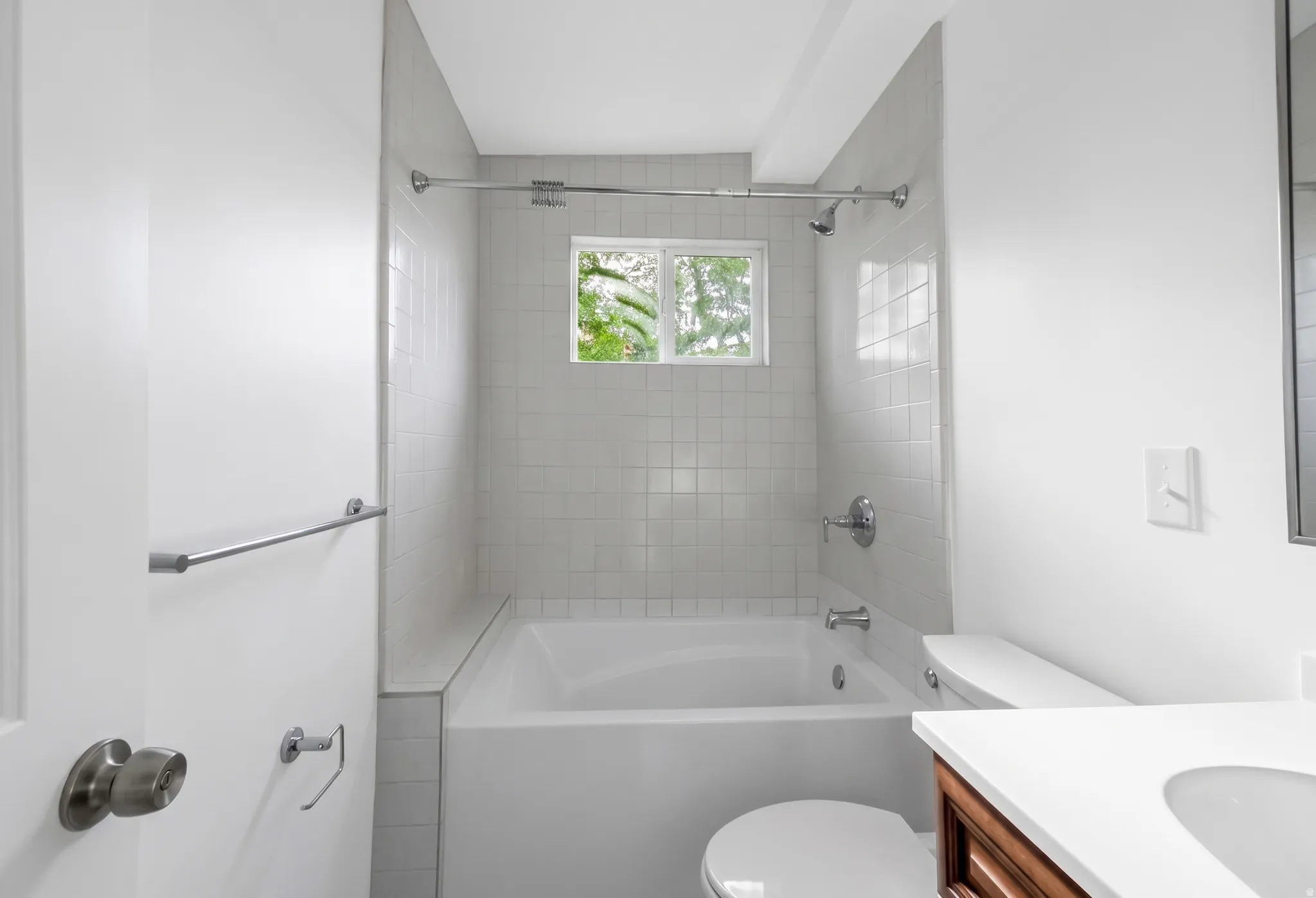 White tiled shower and tub combination