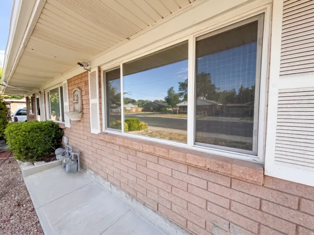 Brick exterior with white window trim and decorative shutters