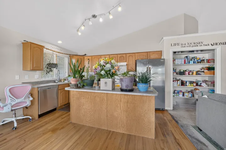 Kitchen with wood-finish flooring, recessed lighting, and track lighting