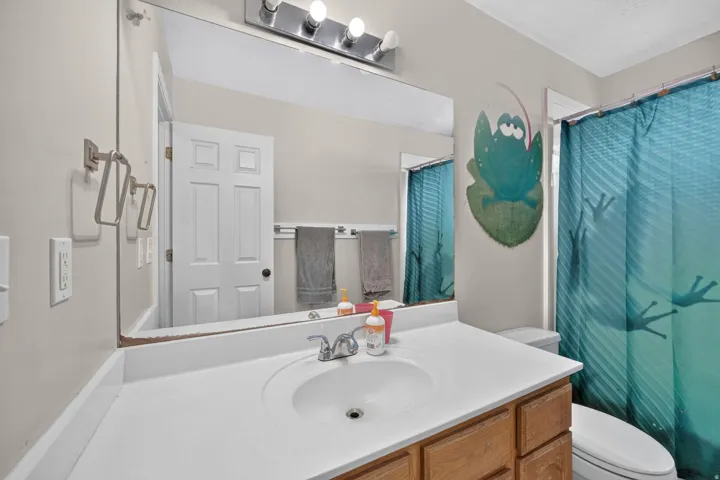 Vanity with an integrated sink, polished chrome faucet, and wood-finish cabinetry