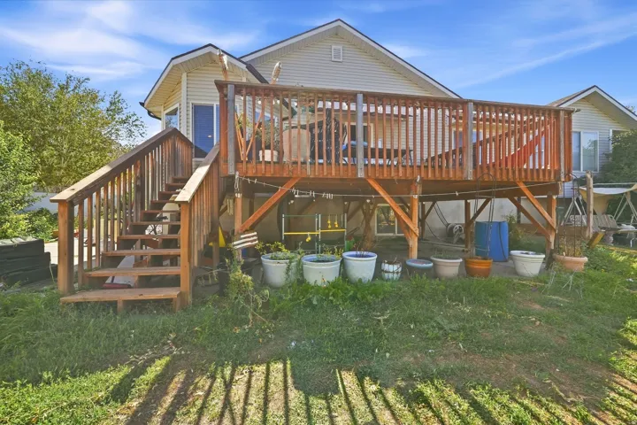 Expansive wooden deck featuring sturdy railings and a full staircase