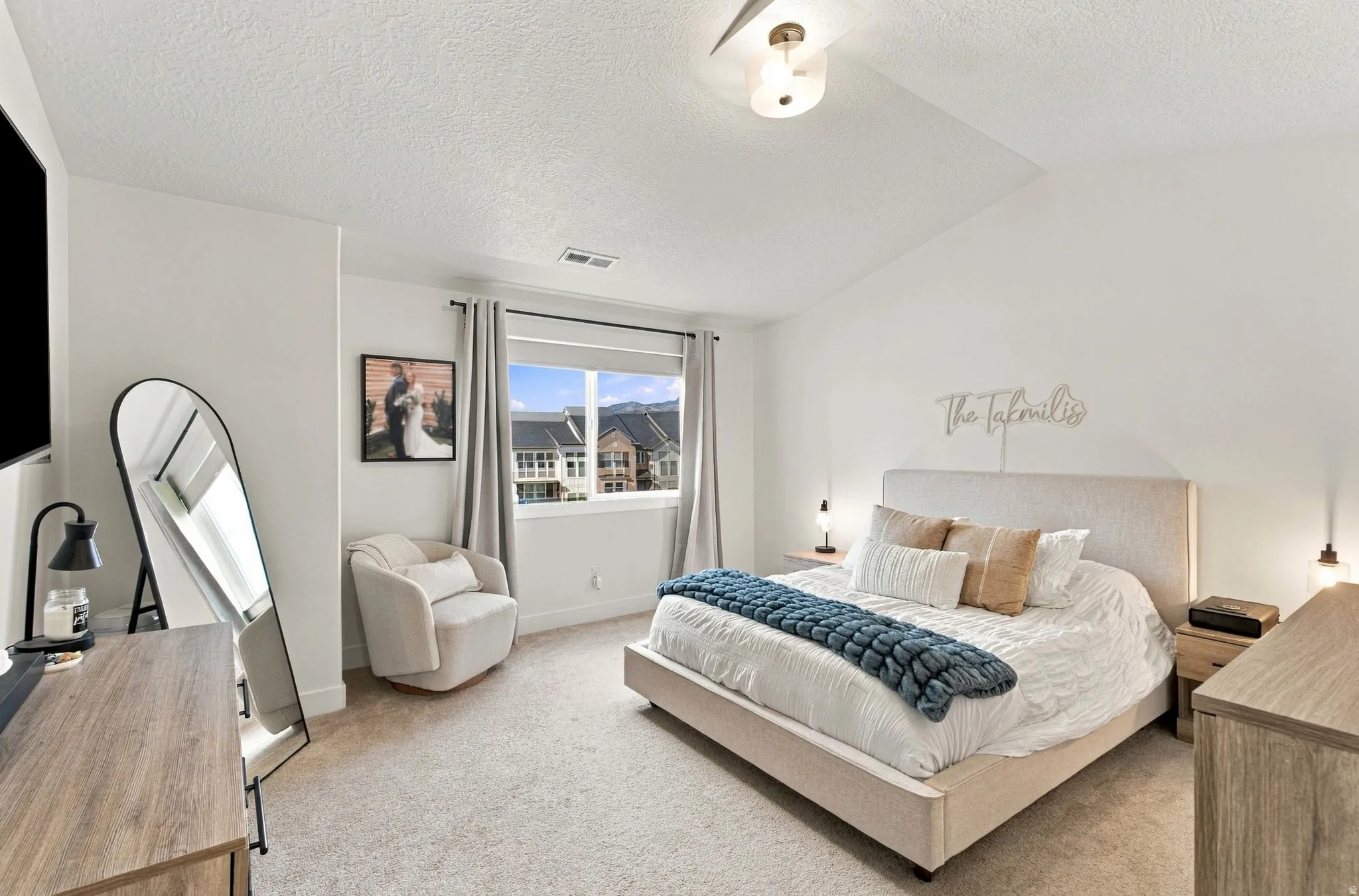 Primary bedroom with expansive outdoor views, vaulted ceiling,