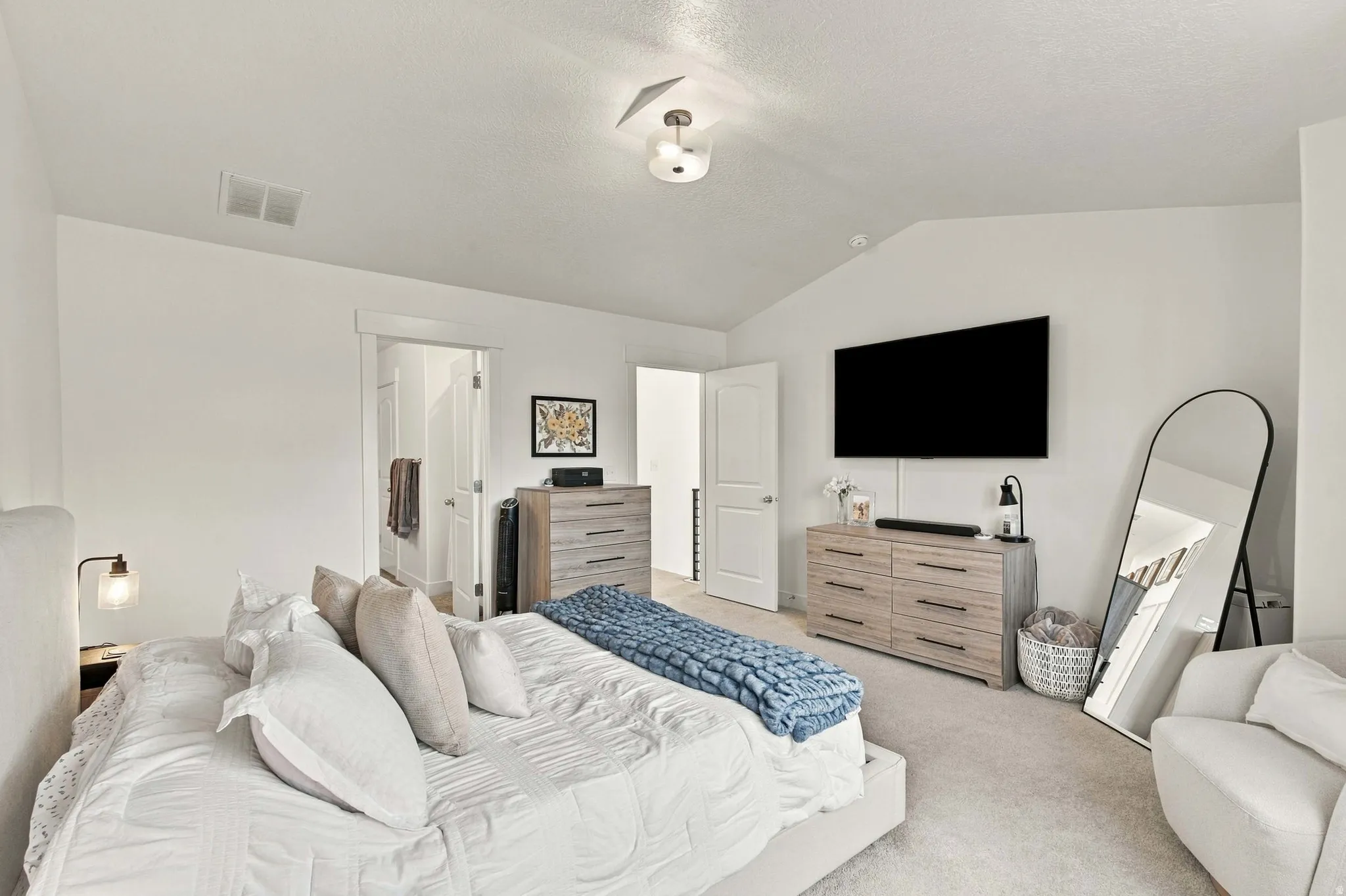 Primary bedroom with Vaulted ceiling and ensuite bathroom