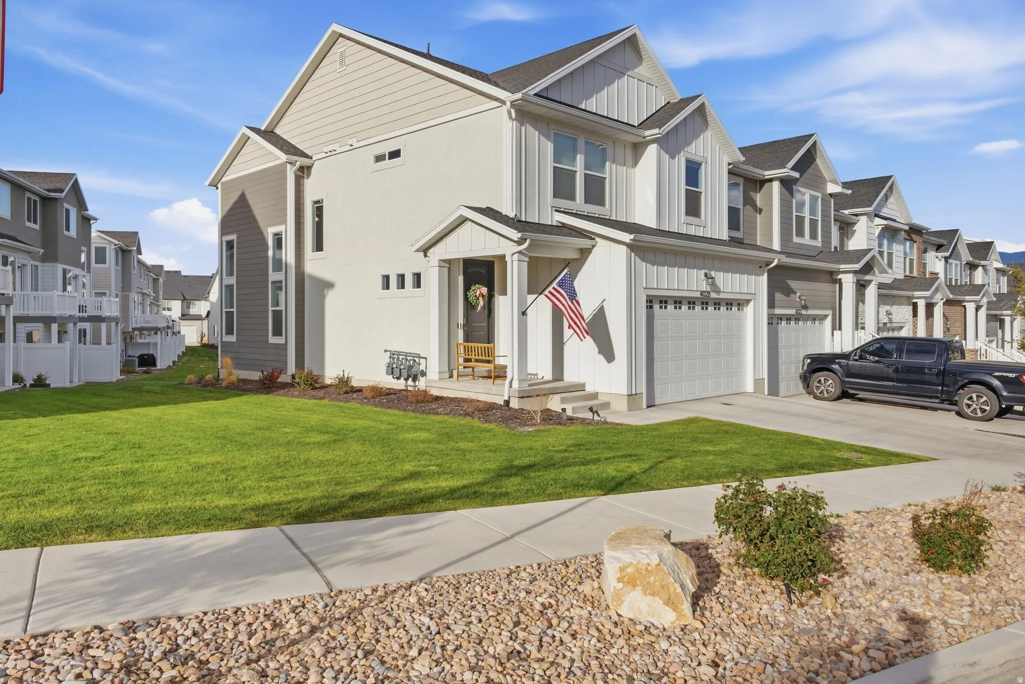 Two-story residence featuring a covered front porch, an attached two-car garage, large side yard and a concrete driveway