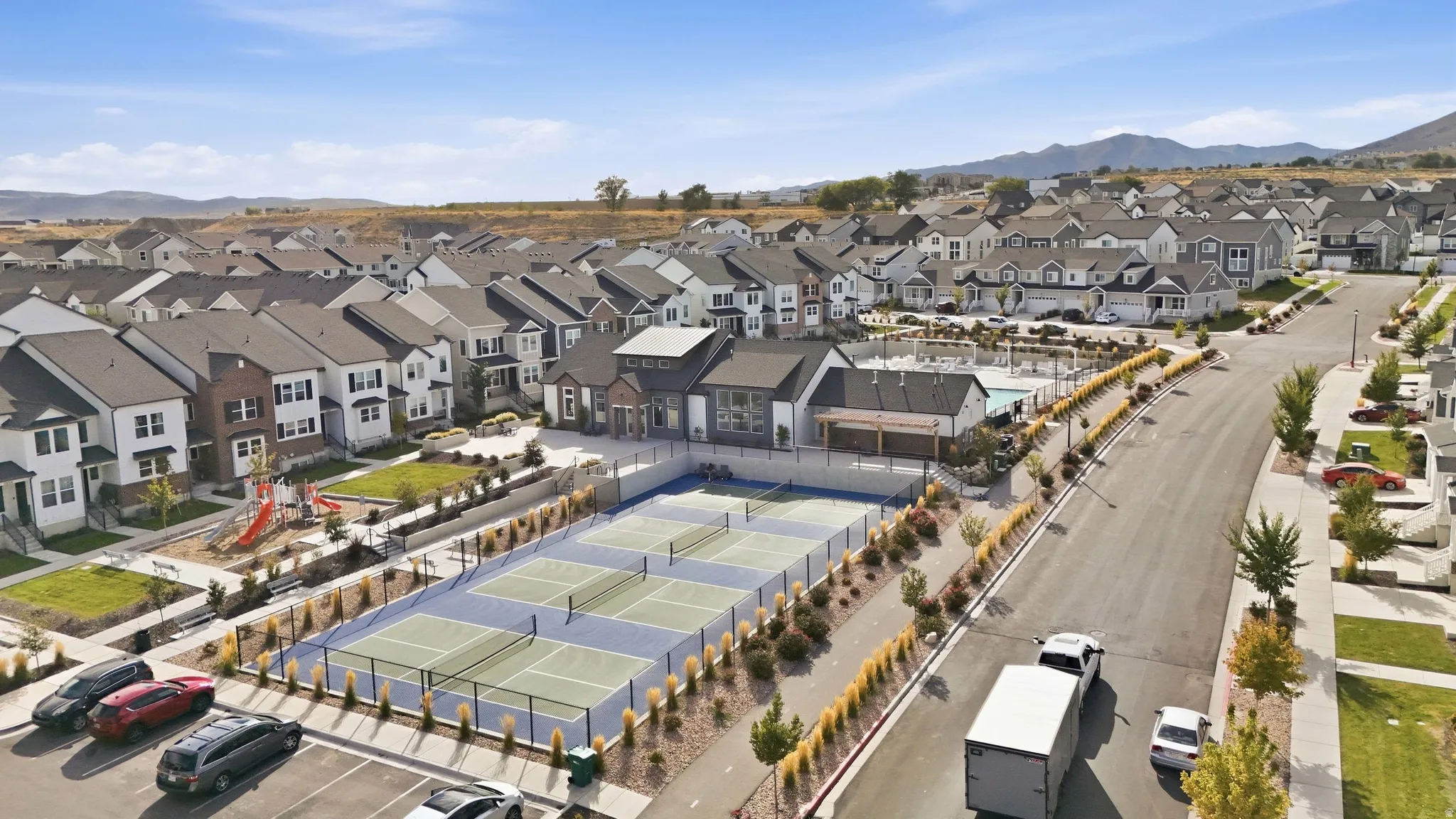 Community featuring multi-sport courts, a swimming pool, and a playground