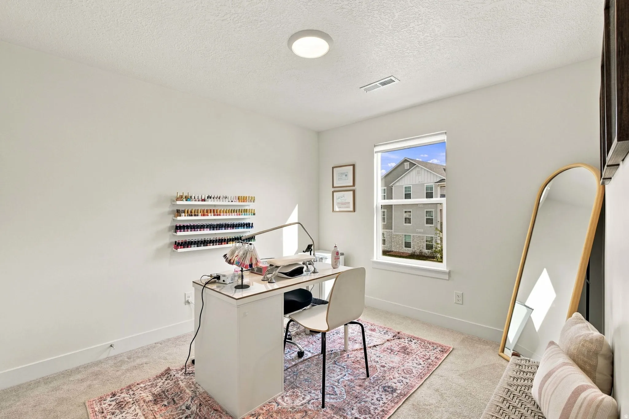 Recessed lighting, large window with white trim, built-in shelving, light-colored walls, and carpeting