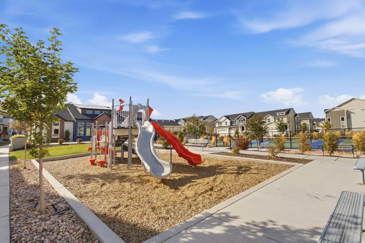 Community playground with wood chip surfacing, slides, and climbing features